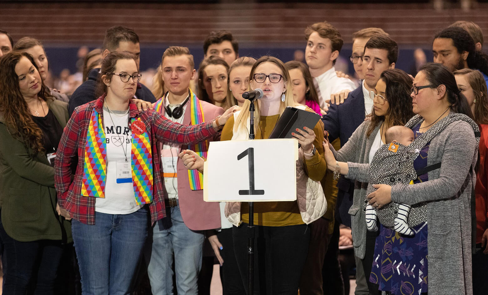 Delegate Shayla Jordan (at microphone) speaks in support of the One Church Plan during the 2019 United Methodist General Conference in St. Louis. She is surrounded by other delegates. Photo by Mike DuBose, UMNS.