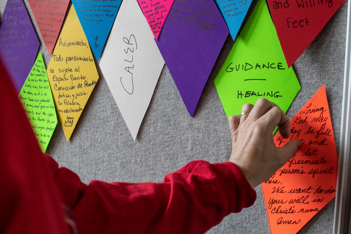 Matt Henson, prayer room volunteer, creates a “stained-glass” wall out of prayers offered by attendees of the 2019 General Conference in St. Louis. Photo by Kathleen Barry, UMNS. Matt Henson, prayer room volunteer, creates a “stained-glass” wall out of prayers offered by attendees of the 2019 General Conference in St. Louis. Photo by Kathleen Barry, UMNS.