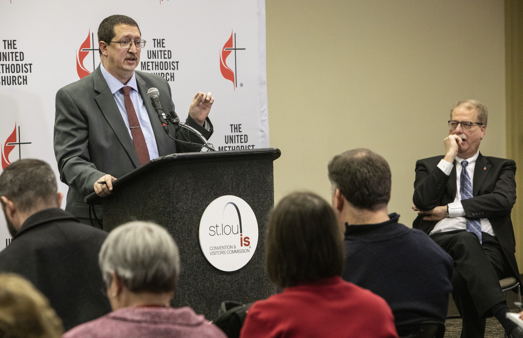 The Rev. Gary W. Graves, secretary of the General Conference, speaks to the press following the conclusion of the special session in St. Louis. To the right is Bishop Kenneth H. Carter. Photo by Kathleen Barry, UMNS.