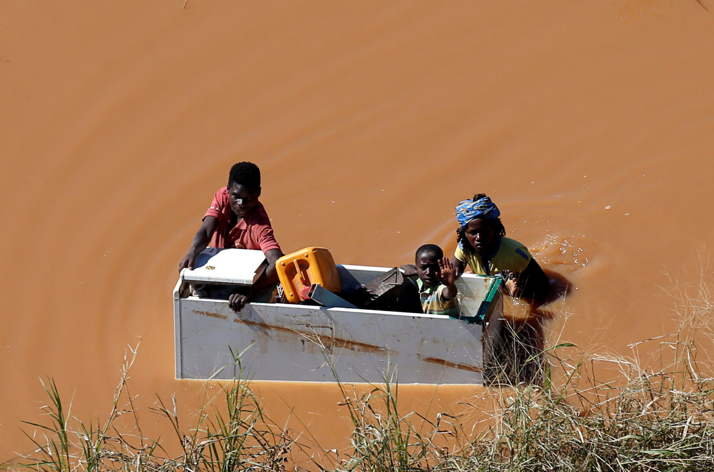 A child is transported inside an empty refrigerator during floods after Cyclone Idai, in Buzi, outside Beira, Mozambique. The United Methodist Committee on Relief has allocated three $10,000 grants for immediate, emergency short-term funding to meet basic human needs of those affected in Mozambique, Zimbabwe and Malawi. Photo by Siphiwe Sibeko, REUTERS