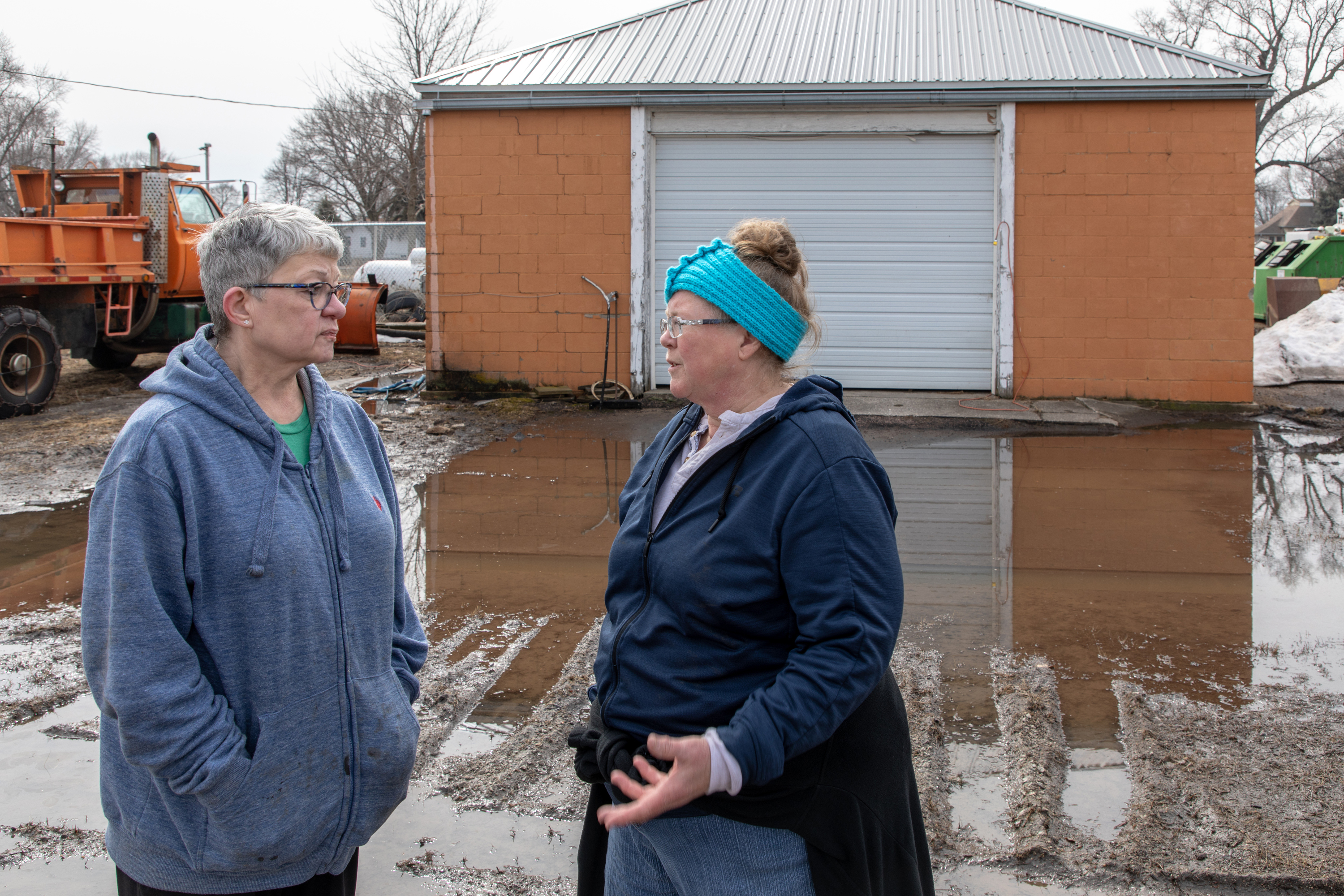 The Revs. Terra Amundson (left) and Catie Newman of the Iowa Conference discuss church response to flooding in the Missouri River basin in Hornick, Iowa. Amundson is superintendent of the Southwest District and Newman is disaster response coordinator for the conference. Photo by Arthur McClanahan, Iowa Conference.