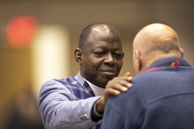 Bishop John K. Yambasu prays with the Rev. Byron Alexander, a conference page, during the 2019 General Conference in St. Louis. Photo by Kathleen Barry, UMNS. Bishop John K. Yambasu prays with the Rev. Byron Alexander, a conference page, during the 2019 General Conference in St. Louis. Photo by Kathleen Barry, UMNS.