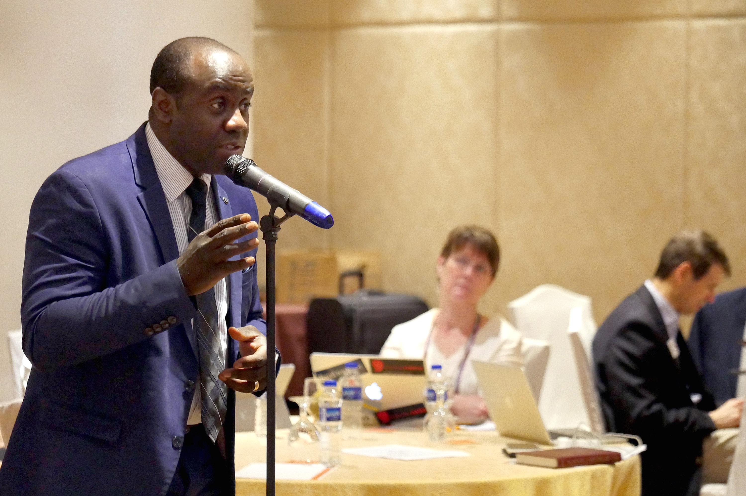 The Rev. Adilson De Almeida of Luanda, Angola addresses fellow members of the Standing Committee on Central Conference Matters, as the Rev. Kimberly Reisman looks on. He and other church leaders at the meeting talked about the fallout of the special General Conference during a March meeting in Manila, Philippines. Photo by Heather Hahn, UMNS.