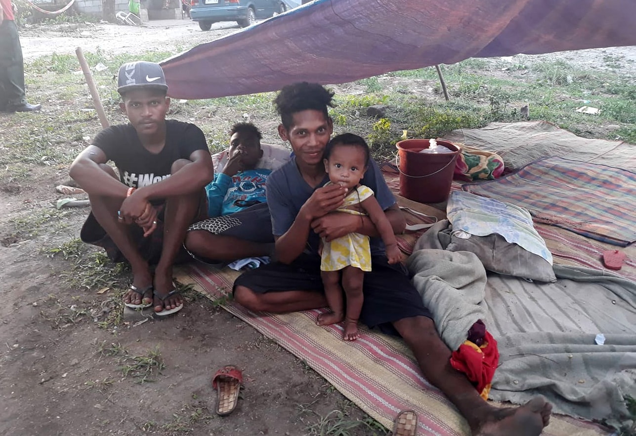 A family spends the night in a makeshift tent in Porac, Philippines, after a powerful earthquake struck the main island of Luzon on Monday. Photo by Rommuel S. Flores. 