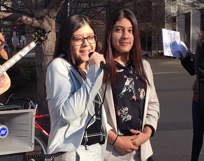 Nelson Pinos’ daughters, Kelly and Arlly, speak at a prayer vigil across from the courthouse in St. Paul, Minn. Photo by Mary Elizabeth Smith.