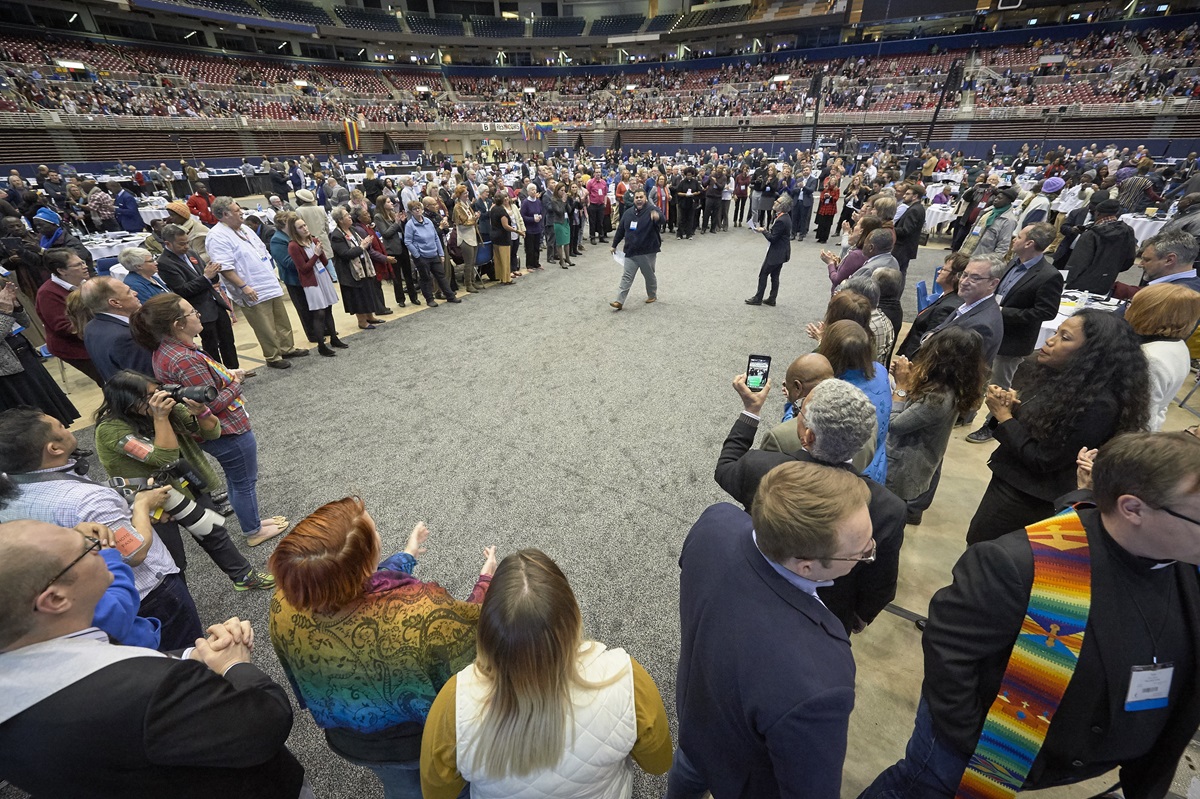 After a Feb. 26, 2019, vote to strengthen church policies about homosexuality, delegate Ian Urriola from New York speaks to other delegates who, in protest, formed a large circle in the center of the plenary floor. Photo by Paul Jeffrey, UMNS. After a Feb. 26, 2019, vote to strengthen church policies about homosexuality, delegate Ian Urriola from New York speaks to other delegates who, in protest, formed a large circle in the center of the plenary floor. Photo by Paul Jeffrey, UMNS.