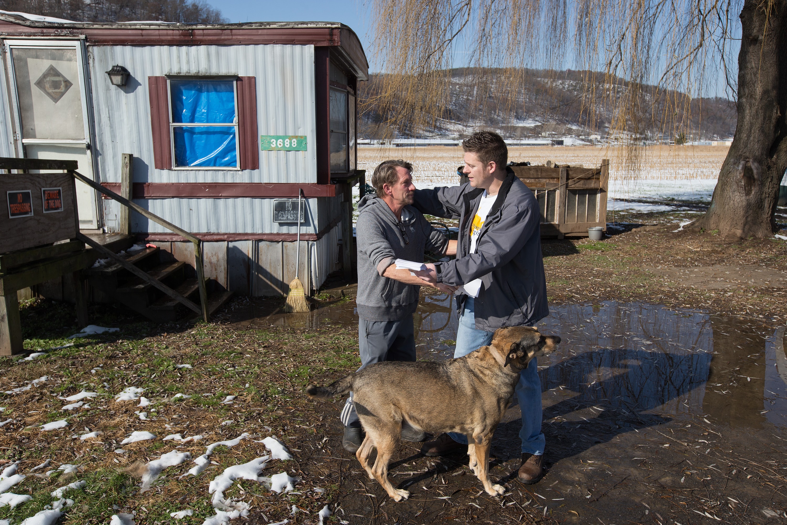 Wayne Worth (right) embraces Roger outside his home in Fisher, W.Va. Worth, a member of United Methodist Temple in Clarksburg, was passing out flyers containing information about local resources for anyone struggling with addiction, when he met Roger.