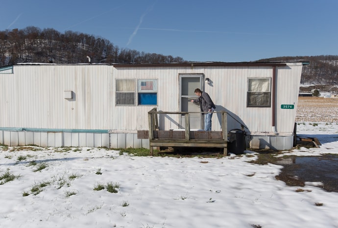 Wayne Worth knocks on the door of a home in Fisher, W.Va., while handing out flyers with resources for people struggling with addiction. “This is a great opportunity for any church in our state, a simple ministry outreach,” he said. “It’s a great way to be a reflection of Christ in the world.”