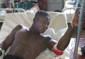 John Kamara rests at Connaught Hospital in Freetown after he and other members of his family were attacked at their home. Photo by Sayo Koroma.