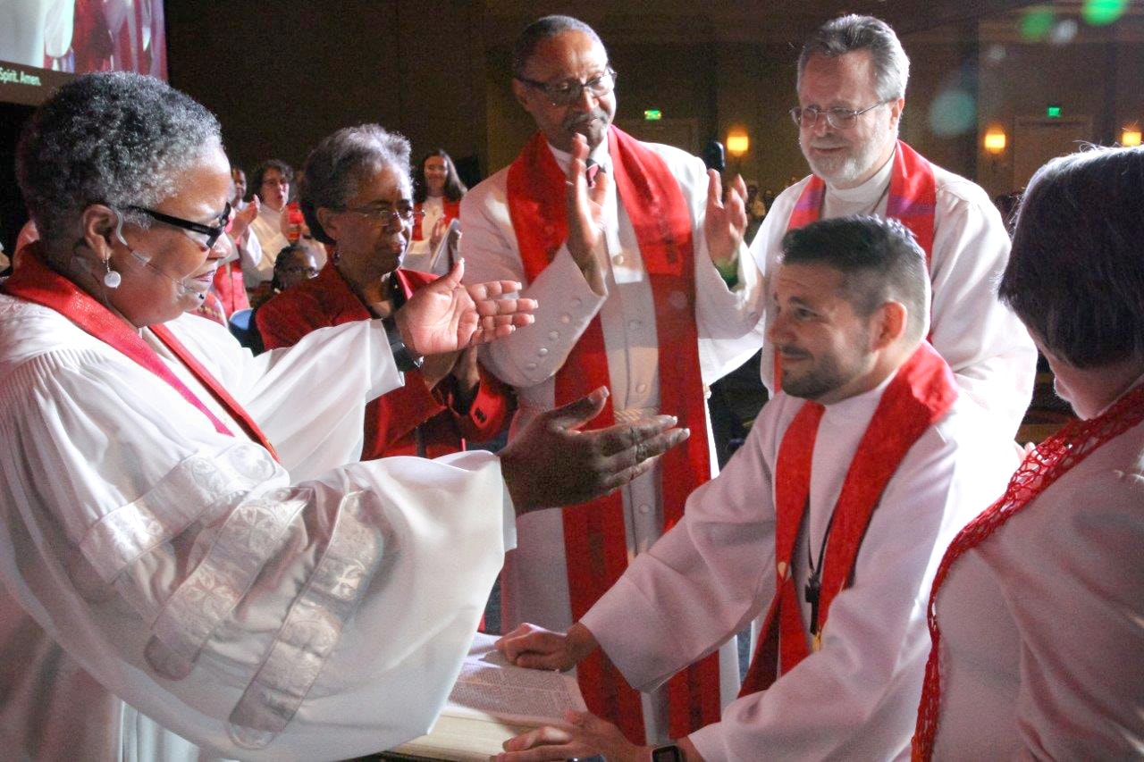 Bishop LaTrelle Easterling ordains the Rev. Joey Heath-Mason as a full elder at the May 31 ordination and commissioning service at the Baltimore-Washington Conference in Baltimore, Md. Heath-Mason is married to a person of the same gender. Photo by Alison Burdett, Baltimore-Washington Conference.