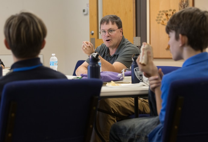 The Rev. Barry Steiner Ball (center) visits with students in the Pre-Work program at House of the Carpenter. Steiner Ball, a retired agent of the Drug Enforcement Administration, heads an initiative of the West Virginia Conference of The United Methodist Church to help churches deal with the opioid crisis. Photo by Mike DuBose, UM News.