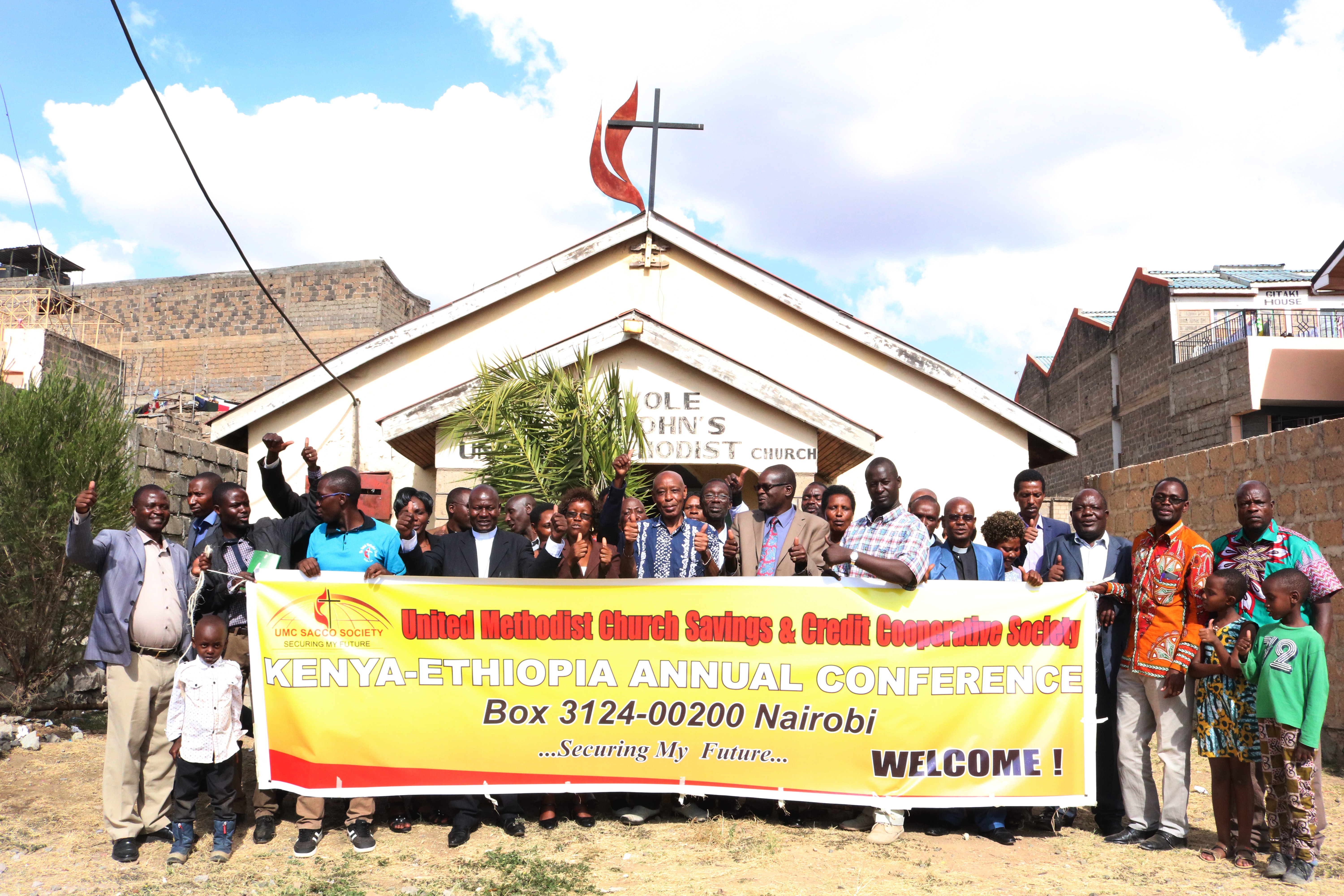 East Africa Bishop Daniel Wandabula stands with others outside Kayole St. John's United Methodist Church in Nairobi, Kenya, where he has launched the opening of The United Methodist Church Savings and Credit Co-Operative Society, the first church-based financial institution in the East Africa episcopal region. Photo by Gad Maiga, UM News.