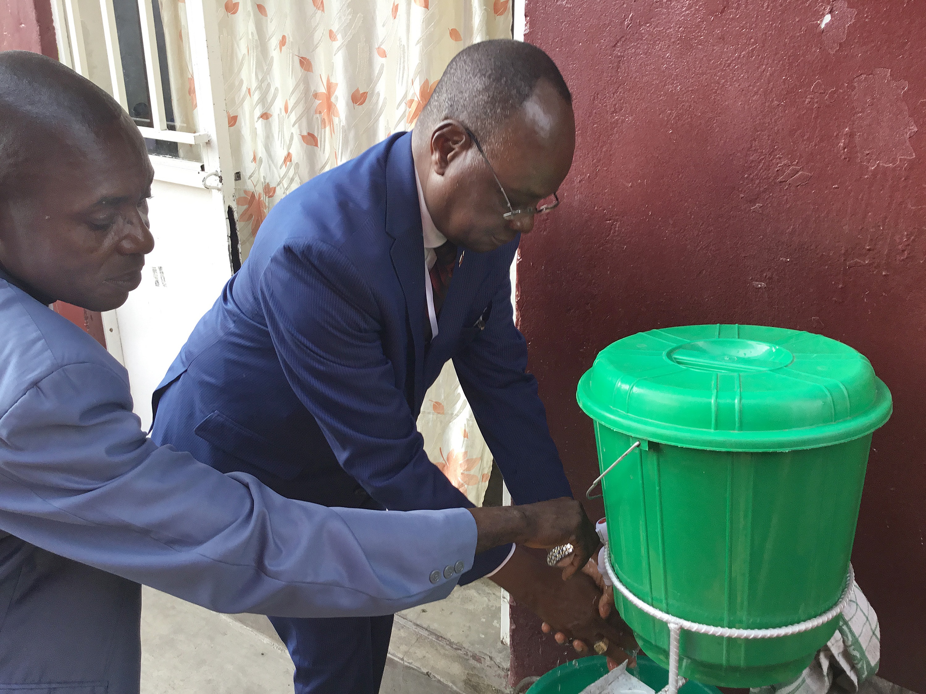 Bishop Gabriel Yemba Unda washes his hands during the Kivu Annual Conference in Goma, Congo. Unda invited conference speakers to observe five minutes of prayer for those affected by the region's Ebola outbreak, which began last August. Photo by Philippe Kituka Lolanga, UM News.