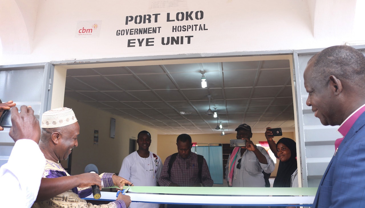 Bishop John K. Yambasu watches the ribbon cutting at the new eye clinic at the Port Loko Government Hospital in northern Sierra Leone. Photo by Phileas Jusu, UM News.