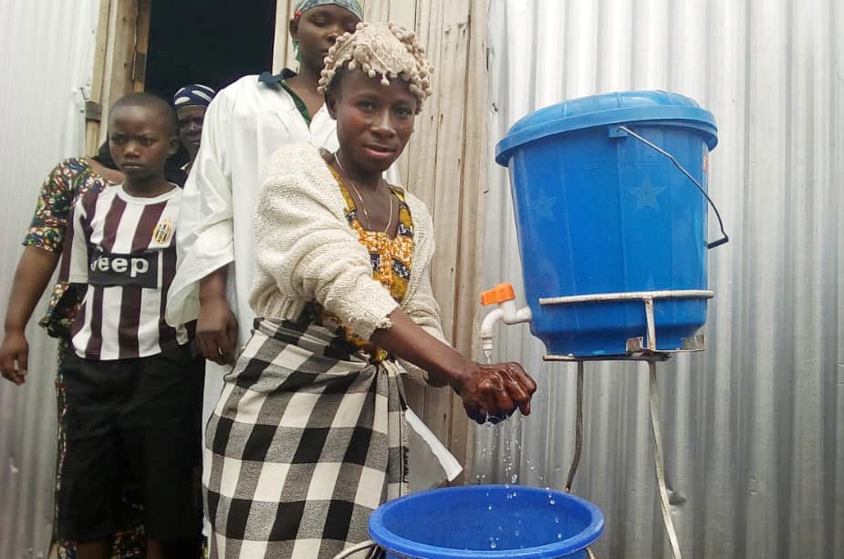 United Methodists from Majengo United Methodist Church in Goma, Congo, wash their hands before a briefing and day of prayer with the Goma District superintendent. Photo by Philippe Kituka Lolonga, UM News.