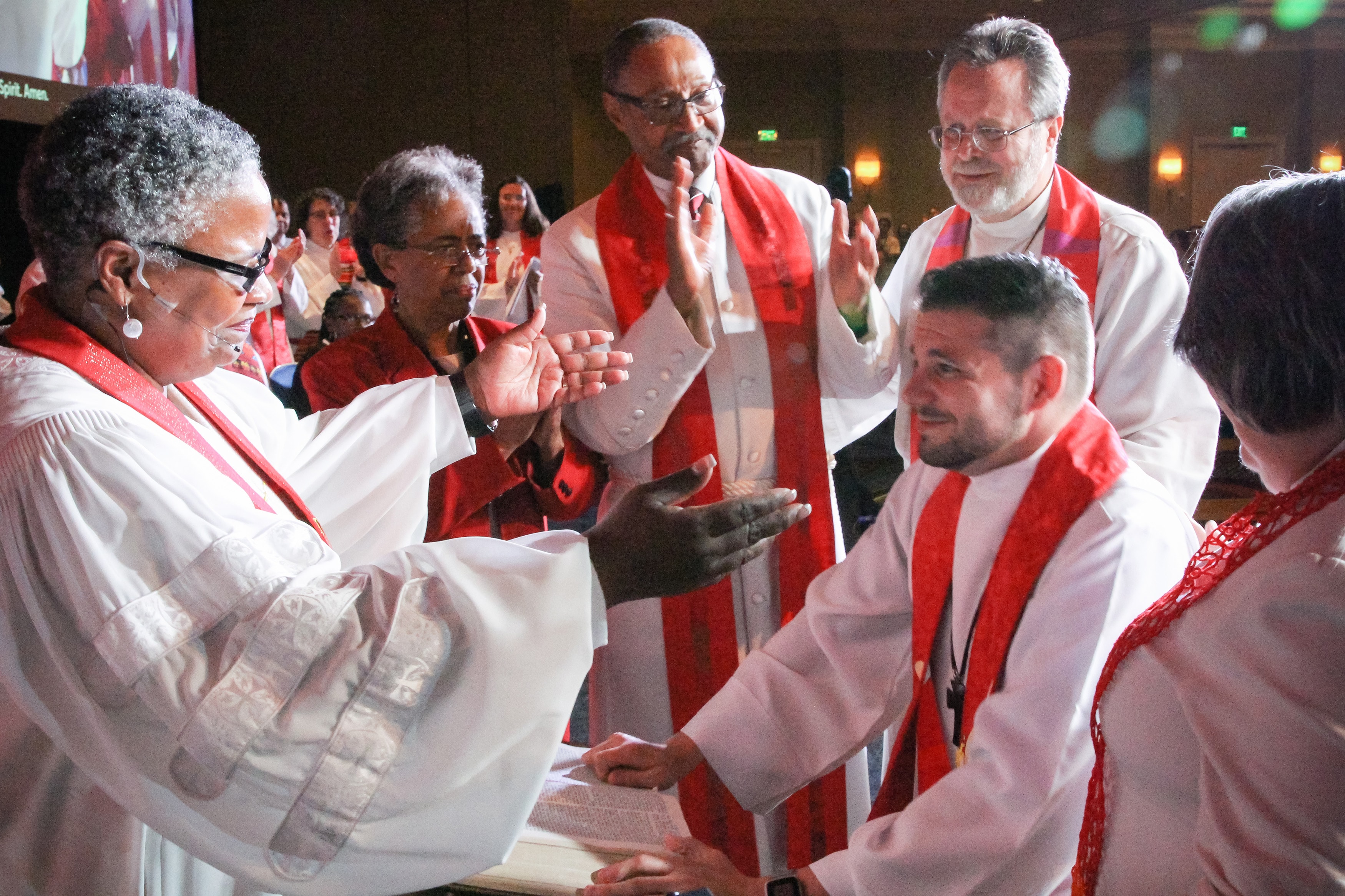 Bishop LaTrelle Easterling, left, greets the Rev. Joey Heath-Mason immediately after ordaining him as a full elder. Photo by Alison Burdett, Baltimore-Washington Conference.