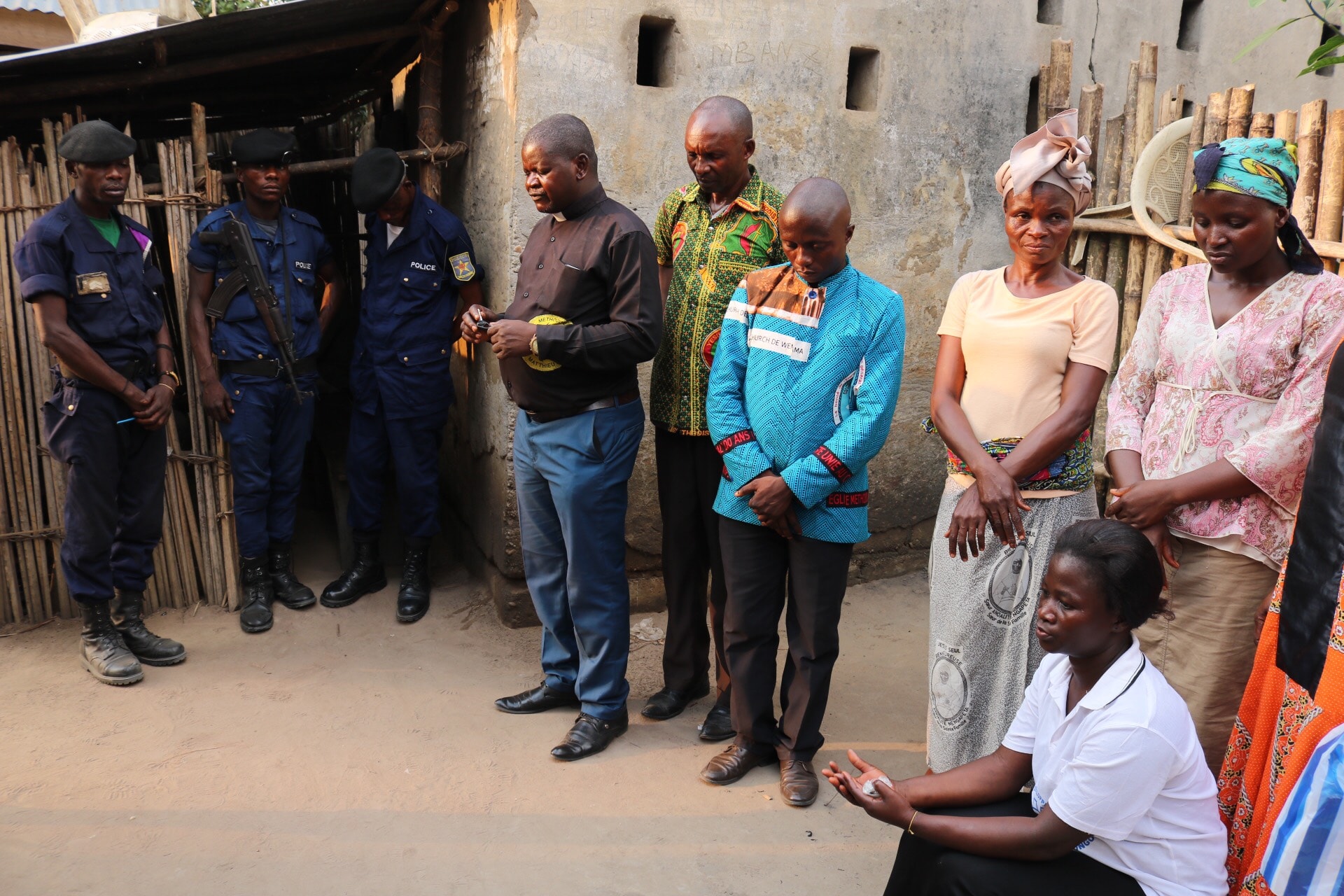 Le Rév. Robert Shuyaka Onakoy, chef de la délégation, dirige la prière dans la cour de la Prison Centrale de Lodja. Les membres de l’Église Méthodiste Unie de Lodja ont apporté de la nourriture à plus de 130 prisonniers. Photo de François Omanyondo, UM News.
