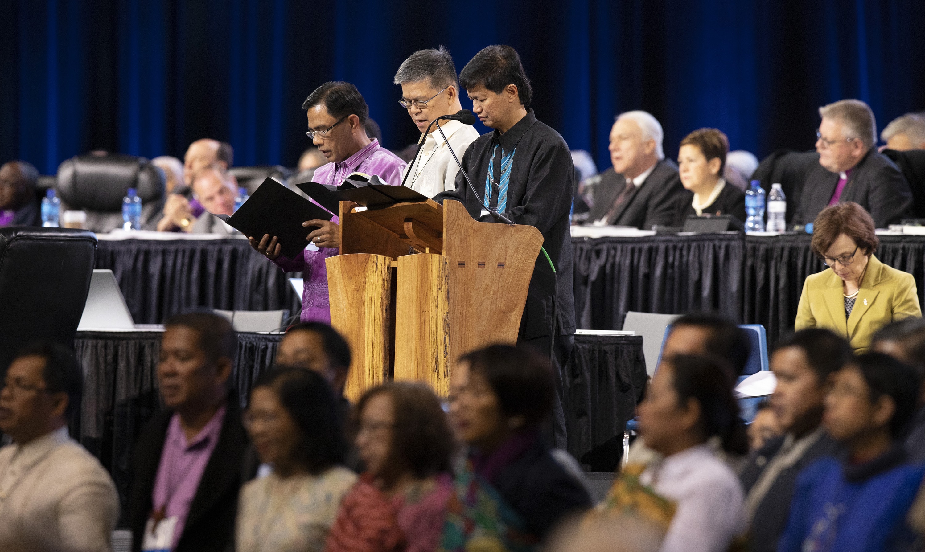 Los obispos Rodolfo Alfonso "Rudy" Juan (izquierda), Ciriaco Q. Francisco (centro) y Pedro M. Torio Jr. dirigen una oración por Filipinas y el sudeste asiático durante la Conferencia General Metodista Unida de 2019, celebrada en San Luis el pasado mes de febrero. El Colegio de Obispos/as de la Conferencia Central de Filipinas, reunido en Manila, firmó una resolución que se opone a la disolución de La Iglesia Metodista Unida. Foto de archivo de Kathleen Barry, Noticias MU.