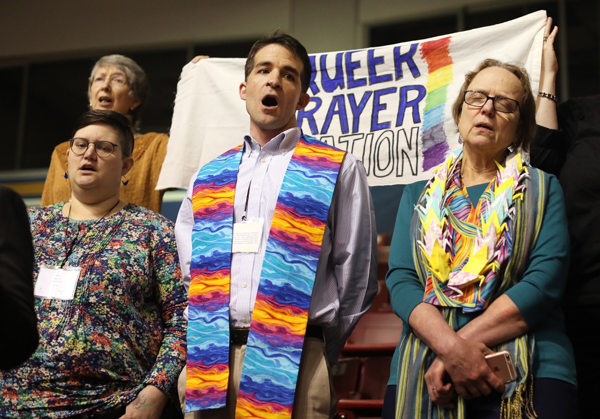 The Rev. Will Green (center) leads the singing of "Jesus Remember Me When You Come Into Your Kingdom" at the "Queer Prayer Station" during the Feb. 23 morning of prayer at the 2019 Special Session of the United Methodist General Conference in St. Louis. Green serves one of nine New England churches looking into leaving the denomination. Photo by Kathleen Barry, UMNS. The Rev. Will Green (center) leads the singing of "Jesus Remember Me When You Come Into Your Kingdom" at the "Queer Prayer Station" during the Feb. 23 morning of prayer at the 2019 Special Session of the United Methodist General Conference in St. Louis. Green serves one of nine New England churches looking into leaving the denomination. Photo by Kathleen Barry, UMNS.