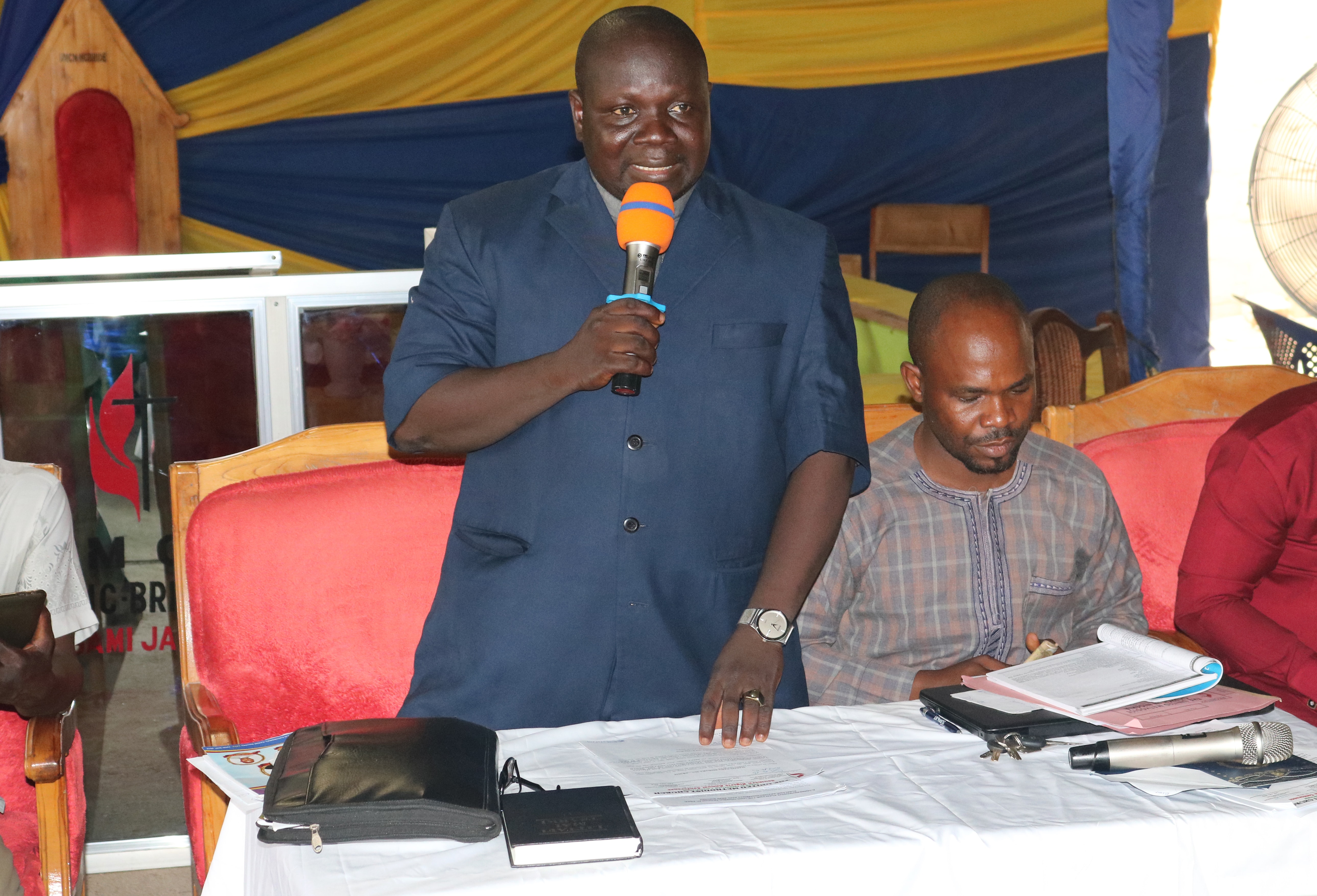 The Rev. Yuyuba B. Yoila, Southern Nigeria Conference administrative assistant to Bishop John Wesley Yohanna, speaks about apportionment giving during a special called session of the Nigeria Episcopal Area in Jalingo, Nigeria. Photo by Sharon Adamu Bambuka, UM News.