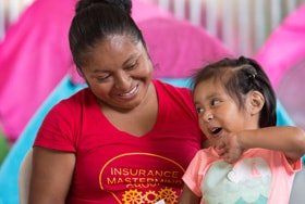 Miriam Magdalena Verdugo Lopez plays with her daughter Maria, 2, at the Movimiento Juventud 2000 shelter for migrants in Tijuana, Mexico. Photo by Mike DuBose, UM News.