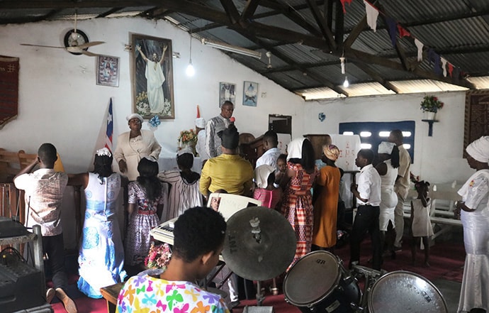 Members of Buduburam United Methodist Church in Buduburam, Ghana, leave after worship on Nov. 3. The church’s pastor, the Rev. James Y. Kaifunbah, is asking for support from the Liberia Conference and global United Methodist Church to help save the small parish. Photo by E Julu Swen, UM News.