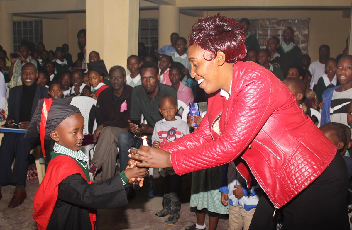 A Congolese student passes on a candle to his teacher as a symbol of successfully completing the Early Years of Education course at Dr. B.T. Cooper United Methodist School in Nairobi, Kenya. Of the 310 students enrolled at the school, 200 are Congolese children with refugee status. Photo by Gad Maiga, UM News. A Congolese student passes on a candle to his teacher as a symbol of successfully completing the Early Years of Education course at Dr. B.T. Cooper United Methodist School in Nairobi, Kenya. Of the 310 students enrolled at the school, 200 are Congolese children with refugee status. Photo by Gad Maiga, UM News.