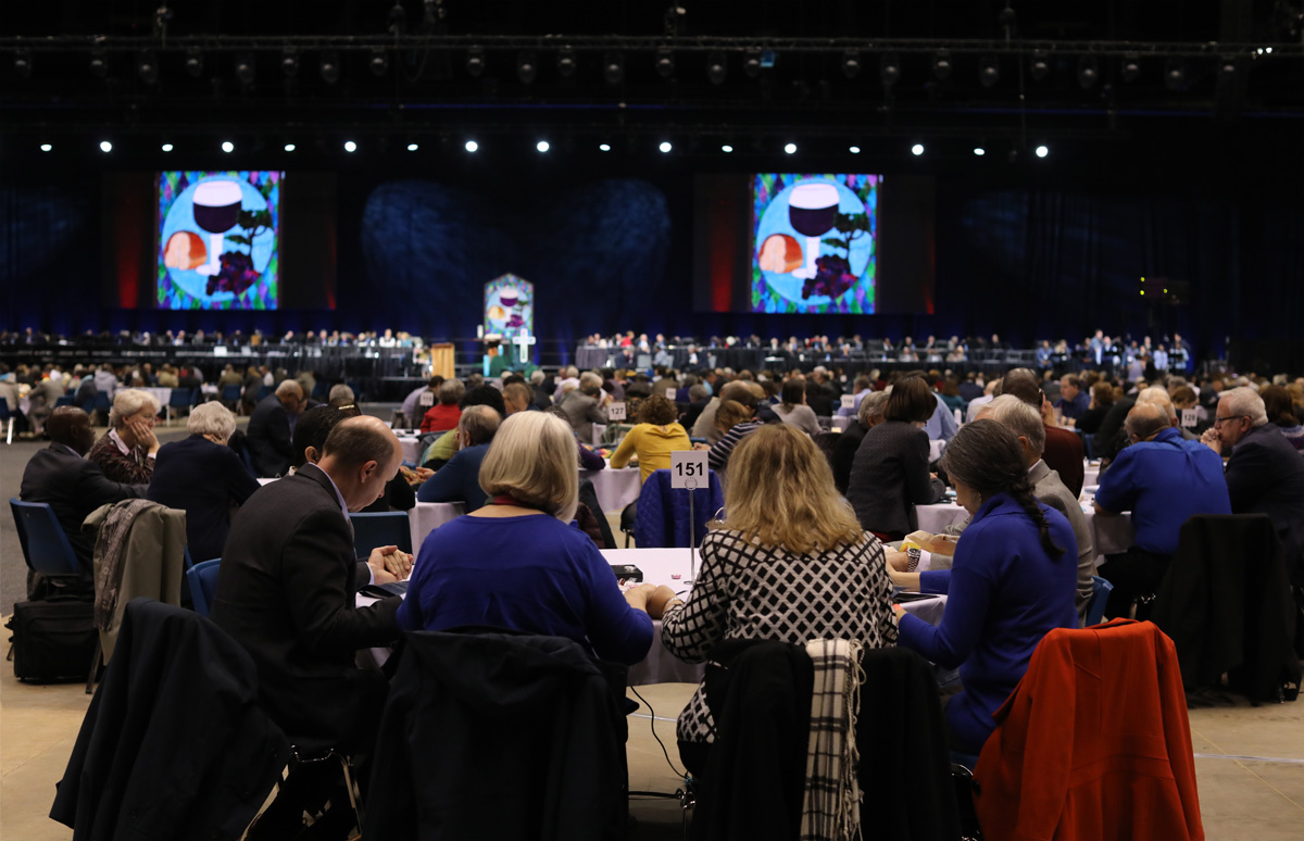 Delegates pause for prayer at the 2019 special General Conference in St. Louis. A group of 2020 General Conference delegates and other church leaders from Africa, Europe and the Philippines is proposing a new form of unity. File photo by Kathleen Barry, UM News.