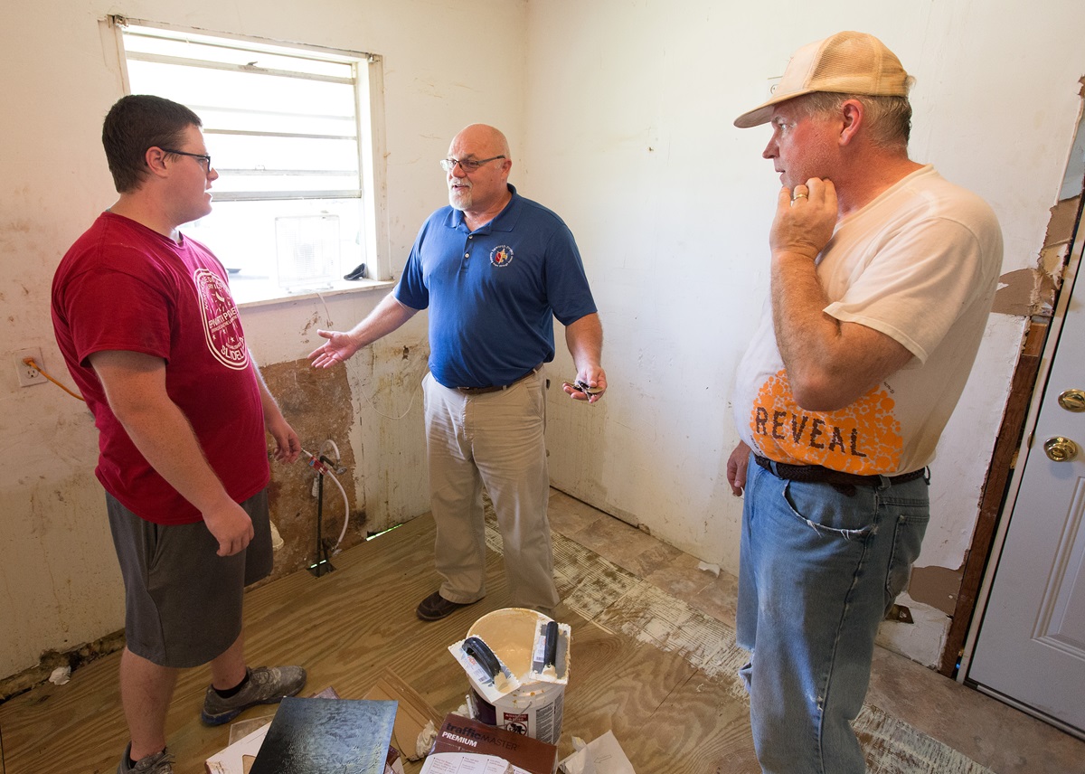 Dale Kimball (center) checks in with Nicholas Eldred (left) and Jerry Rouse on the progress of repairs to a home damaged by Hurricane Katrina in Slidell, La. The Epworth Project, which hosts volunteers from across the country, has a full slate of recovery projects underway 10 years after Hurricane Katrina. Kimball is executive director and Eldred is on staff at the Epworth Project. Rouse is helping lead a youth teach from Wichita Falls (Texas) First United Methodist Church. Photo by Mike DuBose, UMNS. Dale Kimball (center) checks in with Nicholas Eldred (left) and Jerry Rouse on the progress of repairs to a home damaged by Hurricane Katrina in Slidell, La. The Epworth Project, which hosts volunteers from across the country, has a full slate of recovery projects underway 10 years after Hurricane Katrina. Kimball is executive director and Eldred is on staff at the Epworth Project. Rouse is helping lead a youth teach from Wichita Falls (Texas) First United Methodist Church. Photo by Mike DuBose, UMNS.