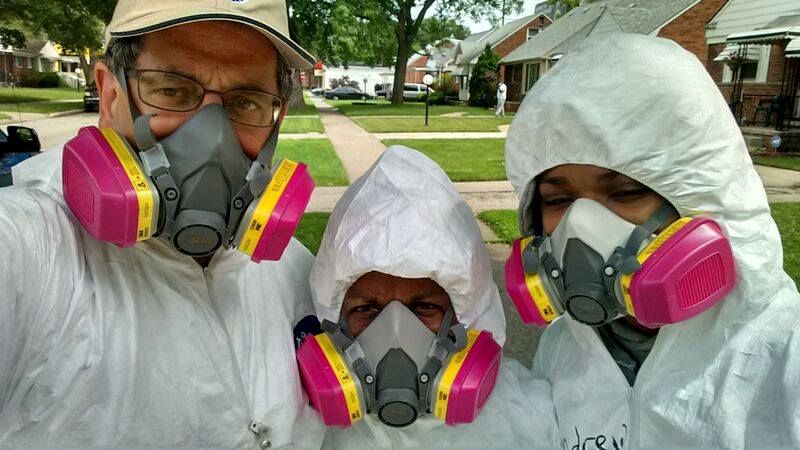 Volunteers wearing protective gear gather to help homeowners in Detroit who were hit by floods in 2014. From left are Lawrence Matthews of the Mennonite Disaster Service, Cheryl Tipton, disaster case manager with the Northwest Detroit Flood Recovery Project of The United Methodist Church and Andrew Massey, 15, of St. Paul's United Methodist Church in Detroit. Photo courtesy of the Northwest Detroit Flood Recovery Project.