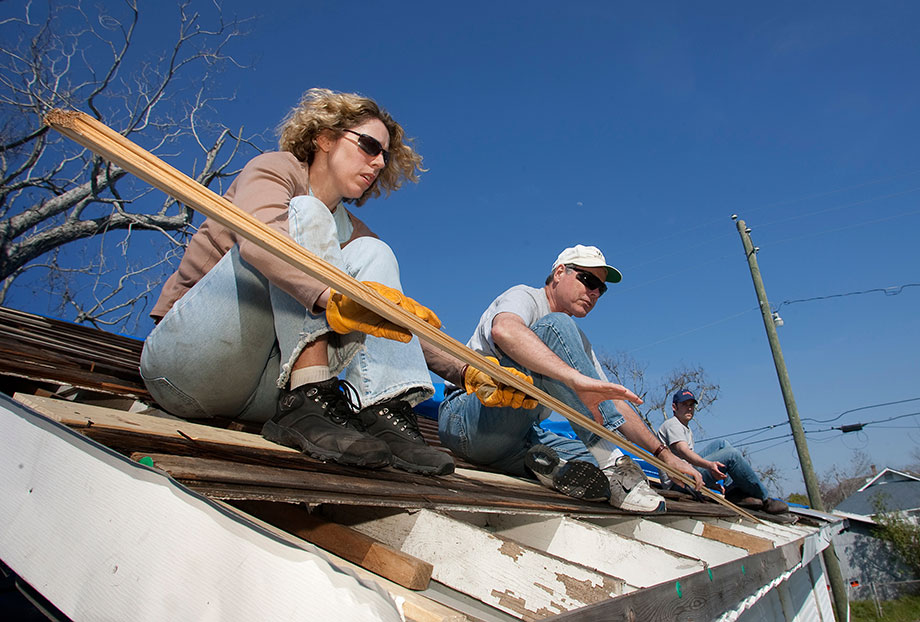 Volunteers from Christ Church United Methodist in New York repair a roof damaged by winds from Hurricane Katrina in Biloxi, Miss., in 2006. From left are Marsha Askins, the Rev. Richard Allen and Chris Andrews. Collaborative relationships established between faith-based, secular and governmental groups in the recovery from Hurricane Katrina have changed the face of local disaster response, relief officials said. File photo by Mike DuBose, UMNS.