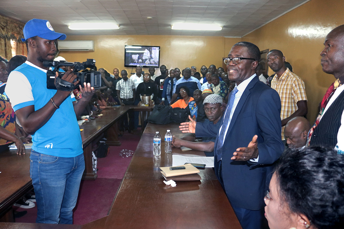 The Rev. Solomon Rogers speaks to a crowd gathered for a special handoff ceremony Jan. 15 in western Freetown, Sierra Leone. The event marks the end of a seven-year land dispute between The United Methodist Church’s Sierra Leone Conference and neighboring Masantigie community. Photo by Phileas Jusu, UM News.