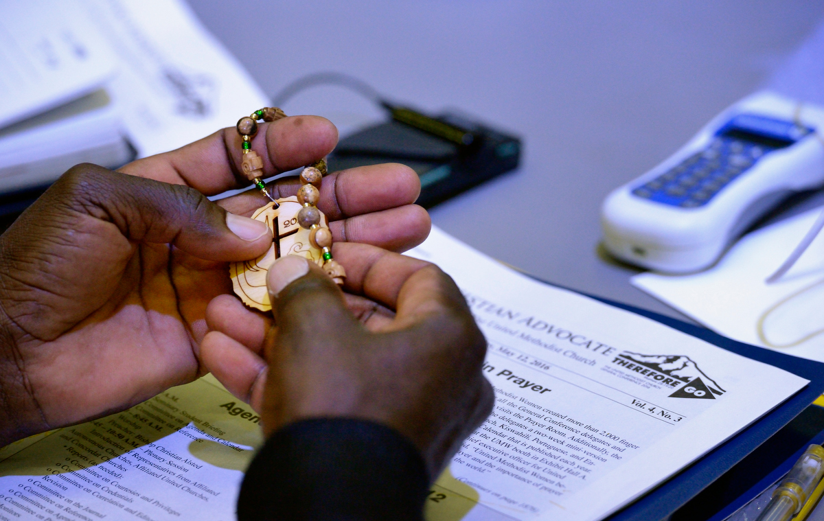 A delegate handles prayer beads during prayer at the 2016 United Methodist General Conference in Portland, Ore. With the coronavirus delaying the 2020 General Conference, church leaders hope United Methodists can experience more time to pray and be the church. File photo by Paul Jeffrey, UM News. A delegate handles prayer beads during prayer at the 2016 United Methodist General Conference in Portland, Ore. With the coronavirus delaying the 2020 General Conference, church leaders hope United Methodists can experience more time to pray and be the church. File photo by Paul Jeffrey, UM News.