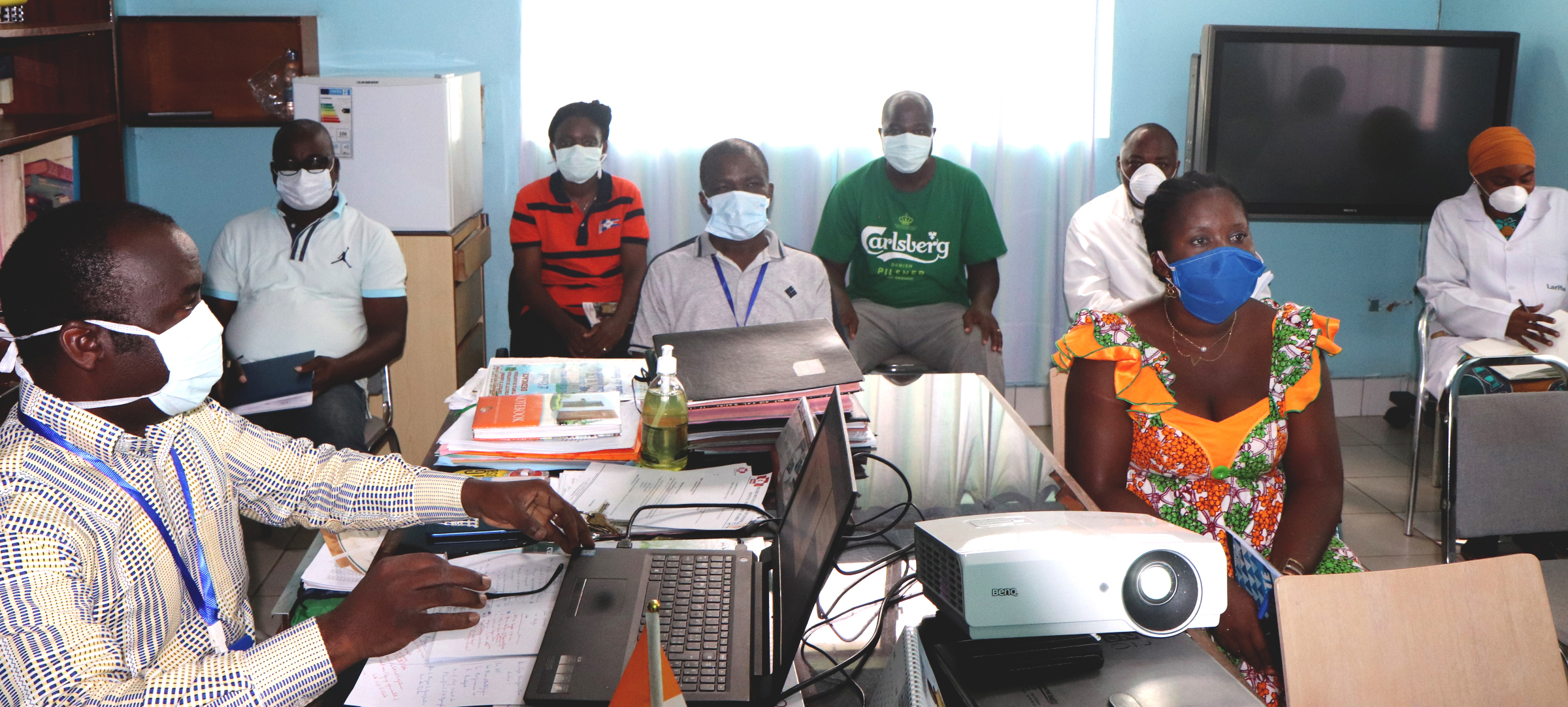 Dr. Daniel Ahui (left), a specialist in infectious and tropical diseases and director of Dabou United Methodist Hospital in Dabou, Côte d'Ivoire, trains pharmacy and laboratory staff on how to deal with suspected and confirmed COVID-19 cases. Although there are no cases of the coronavirus in this city yet, the hospital is taking steps to avoid being caught off guard. Photo by Isaac Broune, UM News.