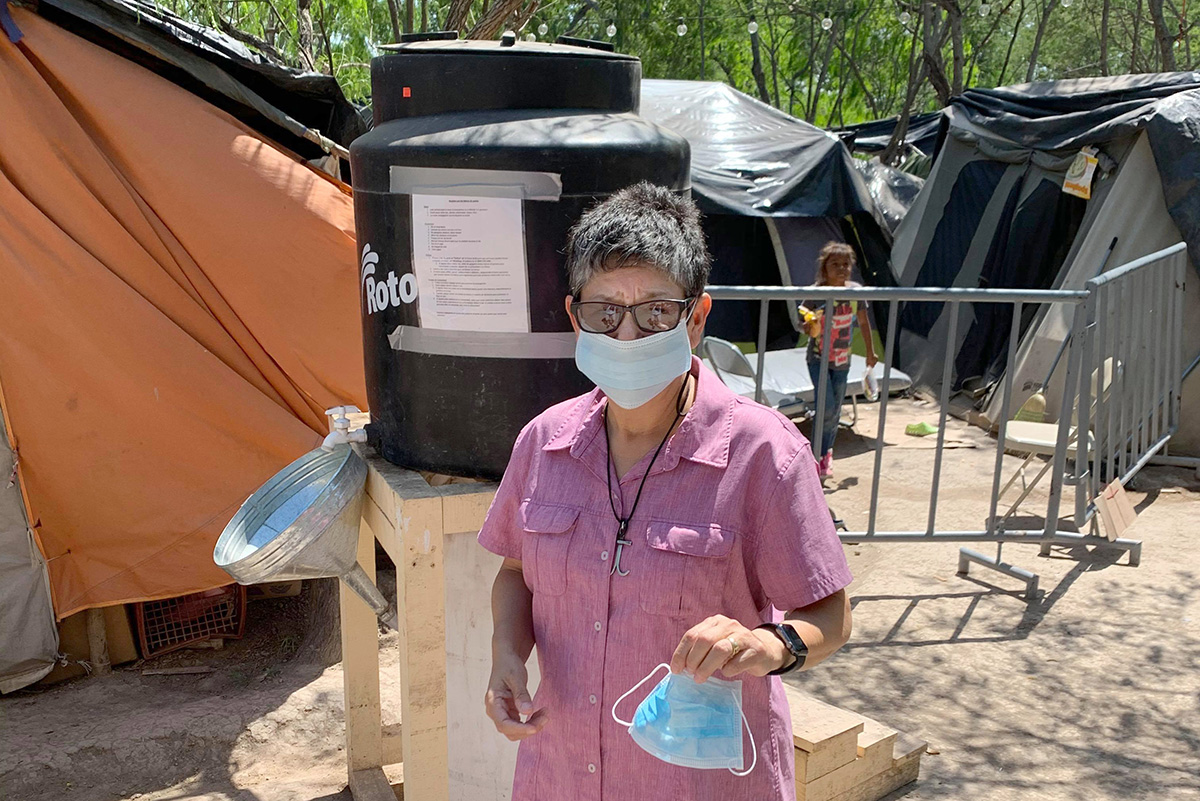 United Methodist deaconess Cindy Johnson regularly visits with migrants living in a tent camp in Matamoros, Mexico, while they seek asylum in the United States. Fear of the coronavirus has stopped people like Johnson from being able to minister to them face-to-face. Photo courtesy of Cindy Johnson.