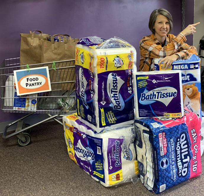 The Rev. Chris Jorgensen, pastor of Hanscom Park United Methodist Church in Omaha, Nebraska, poses by some of the 200 rolls of toilet paper the church donated to Together Omaha, a homeless service organization. They did hold back a small amount for the church, which has two people working in the office during the pandemic. Photo courtesy of Omaha Hanscom Park United Methodist Church.