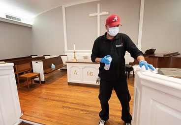 Custodian James Jimmerson disinfects the chancel area to prevent any possible spread of the coronavirus at Belmont United Methodist Church in Nashville, Tenn., on Sunday, May 10, 2020, after online worship, which is recorded in the chapel. Bishops are setting guidelines, including standards for cleaning, and recommending what they think are appropriate times for the churches in their conference to reopen. Photo by Mike DuBose, UM News. Custodian James Jimmerson disinfects the chancel area to prevent any possible spread of the coronavirus at Belmont United Methodist Church in Nashville, Tenn., on Sunday, May 10, 2020, after online worship, which is recorded in the chapel. Bishops are setting guidelines, including standards for cleaning, and recommending what they think are appropriate times for the churches in their conference to reopen. Photo by Mike DuBose, UM News.