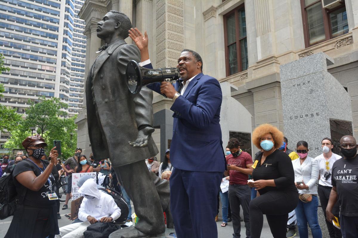 The Rev. Gregory Holston speaks during a May 31 demonstration at Philadelphia City Hall in honor of George Floyd. Holston, a United Methodist pastor and adviser to Philadelphia’s district attorney, stands beside a statue of slain voting rights activist Octavius Catto. Photo by Samaria Bailey, Philadelphia Tribune.