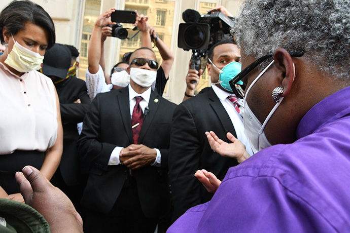 United Methodist Bishop LaTrelle Easterling (right) offers a prayer during an interfaith vigil near the White House on June 3. Washington Mayor Muriel Bowser (left) joined the prayer vigil. Photo by Melissa Lauber, Baltimore-Washington Conference.