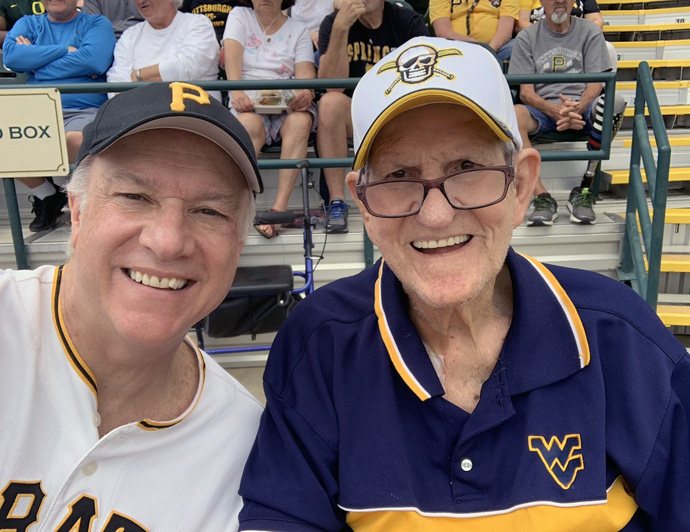 New York Conference Bishop Thomas Bickerton (left) with his father, Jim Bickerton, at a Pittsburgh Pirate spring training game in Bradenton, Fla., in 2019. Jim Bickerton, 84, contracted the coronavirus in his Florida nursing home/rehabilitation center in mid-April but has lately tested negative for the disease. Photo courtesy of Bishop Bickerton.