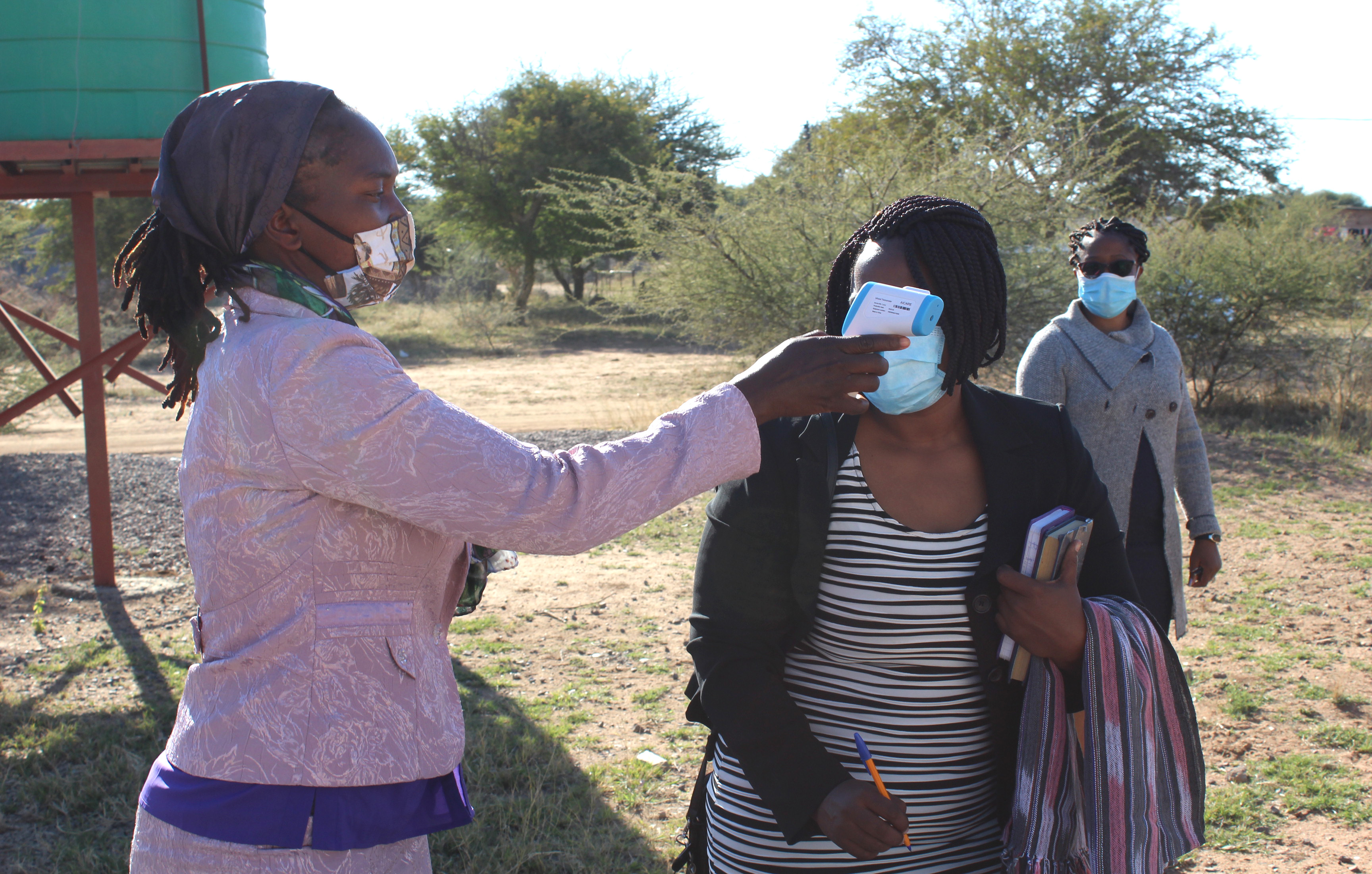 Tariro Chinofura of the Gaberone United Methodist Church health committee checks the temperature of a church member before the first post-lockdown worship service May 31 in Gaberone, Botswana. The country lifted the ban on religious gatherings but issued health guidelines targeted at fighting the coronavirus pandemic. Photo by David Mandiyanike, Gaberone United Methodist Church.
