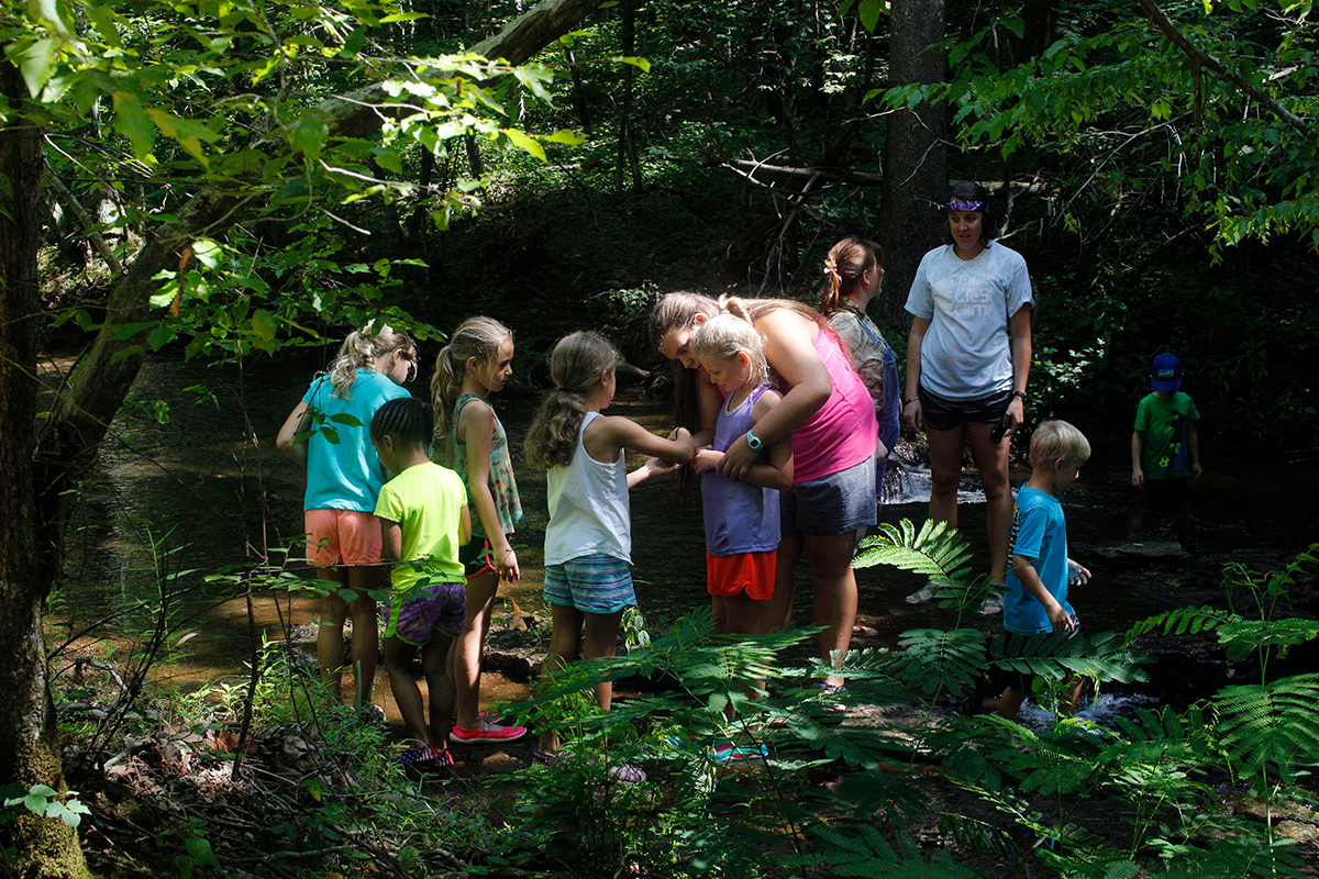 Campers and counselors explore the creek at Cedar Crest Camp in Lyles, Tenn., in 2017. Cedar Crest, like many other United Methodist camps, has suspended operations this summer due to COVID-19. File photo by Kathleen Barry, UM News. Campers and counselors explore the creek at Cedar Crest Camp in Lyles, Tenn., in 2017. Cedar Crest, like many other United Methodist camps, has suspended operations this summer due to COVID-19. File photo by Kathleen Barry, UM News.