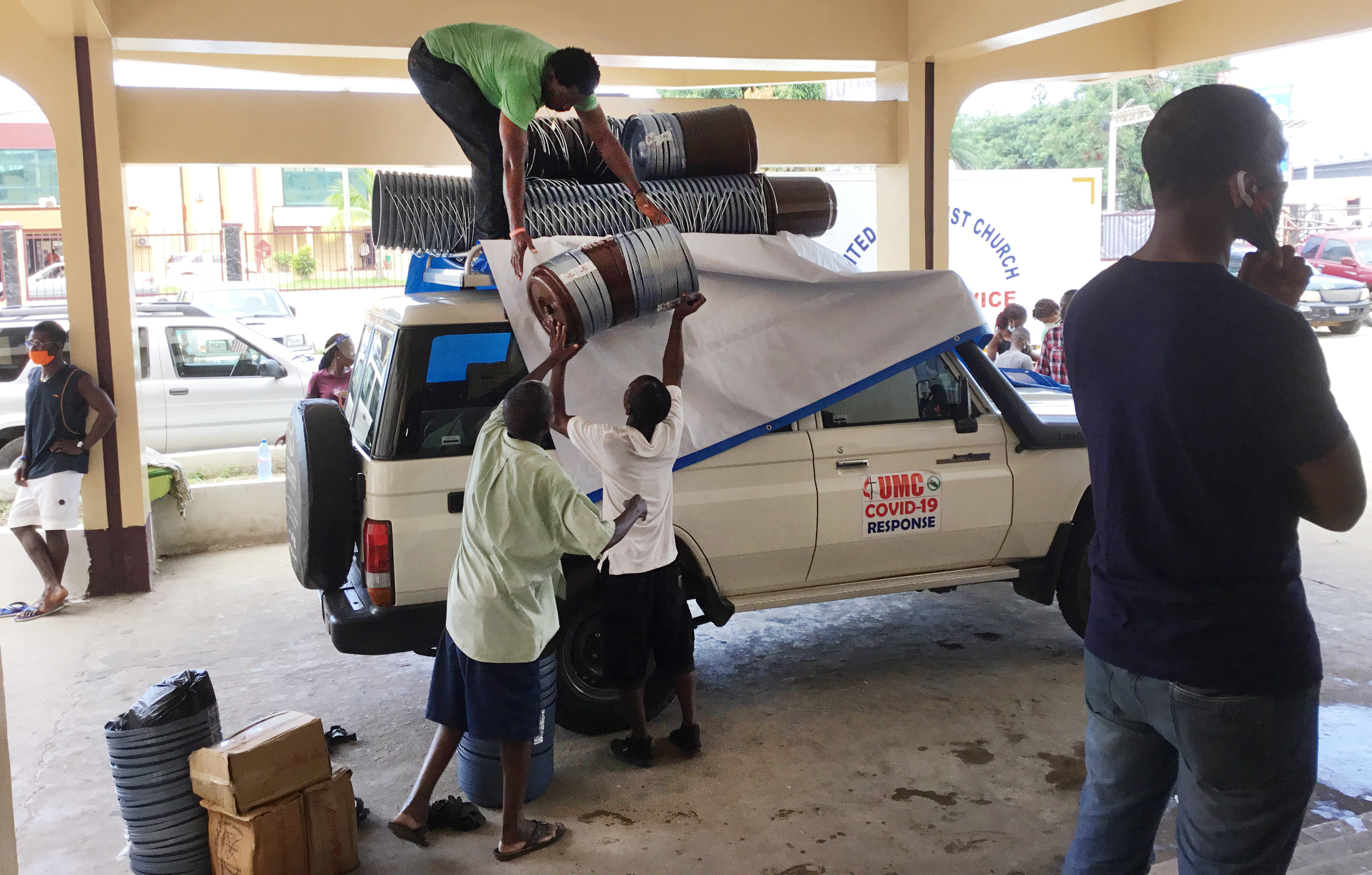 Workers with the church’s Department of Community Services load supplies onto a vehicle to deliver to rural Liberia. The food relief — supported by UMCOR and other global partners — is part of the efforts of The United Methodist Church’s Anti COVID-19 Taskforce. Photo by E Julu Swen, UM News.