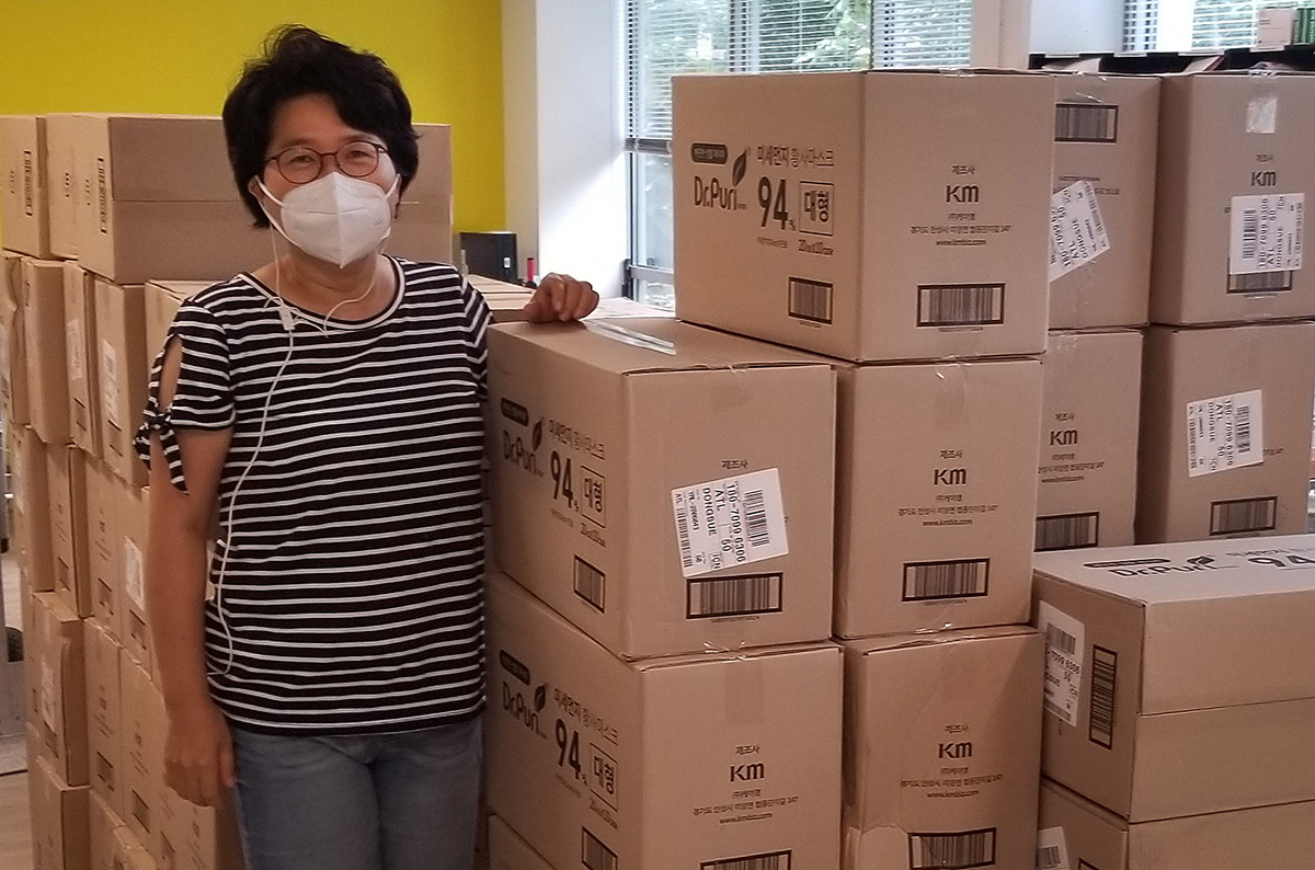 Grace Choi, current Global Ministries missionary in residence and a Yonsei alumnus, stands by a pile of donated masks. Choi worked at Yonsei Severance Hospital before she became a missionary. Photo courtesy of Grace Choi, Global Ministries. Grace Choi, current Global Ministries missionary in residence and a Yonsei alumnus, stands by a pile of donated masks. Choi worked at Yonsei Severance Hospital before she became a missionary. Photo courtesy of Grace Choi, Global Ministries.