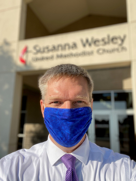 The Rev. Andrew Conard, pastor of Susanna Wesley United Methodist Church in Topeka, Kan., dons a mask for the protection of himself and congregants during worship services. The church resumed worshipping in-person on July 19. Photo courtesy of the Rev. Andrew Conard.