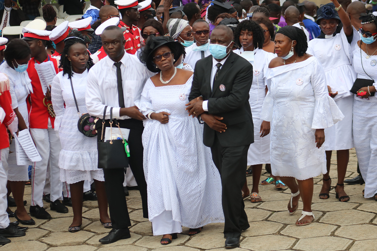Family and friends of Bishop John K. Yambasu, (from left front) Elizabeth Yambasu, Emmanuel Yambasu, widow Millicent Yambasu and Alfred Lansana, arrive at the burial site on the campus of United Methodist University in Freetown, Sierra Leone. Photo by E Julu Swen, UM News.  Family and friends of Bishop John K. Yambasu, (from left front) Elizabeth Yambasu, Emmanuel Yambasu, widow Millicent Yambasu and Alfred Lansana, arrive at the burial site on the campus of United Methodist University in Freetown, Sierra Leone. Photo by E Julu Swen, UM News.