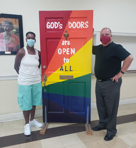 A painted door displayed at Asbury Memorial Church in Savannah, Ga., proclaims, “God’s doors are open to all.” Photo courtesy of Asbury Memorial Church. 