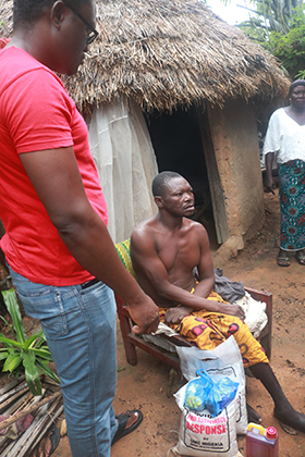 Dr. Godfrey Ogbu (left) talks with villagers during the distribution of food in Saladuna, a village in the Ampandi District of Nigeria. The Nigeria Episcopal Area provided food assistance in all four of its conferences with money provided through an UMCOR COVID-19 Response Fund grant. Photo by Richard Fidelis, UM News.