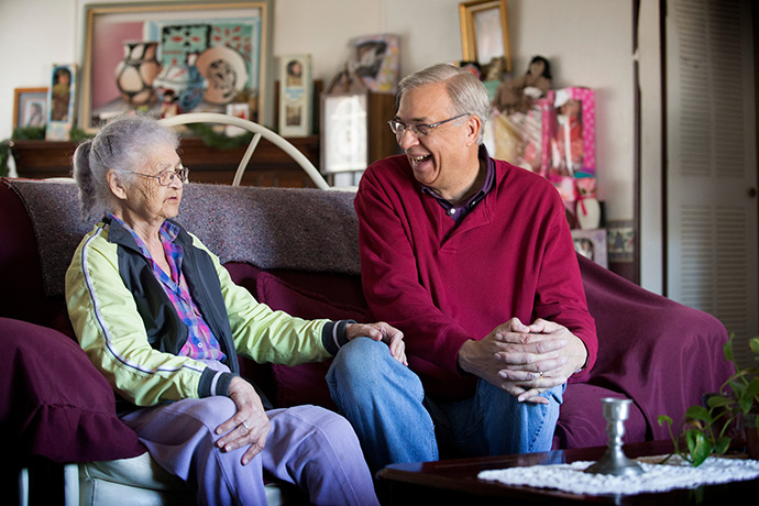 United Methodist Home Missioner Gary Locklear visits with Strawdie Locklear, then 93, (no relation) at her home in Pembroke, N.C., in 2014. Gary was her teacher in the Senior Adult Sunday school class at Sandy Plains United Methodist Church in Pembroke for 30 years. Gary Locklear died Sept. 10 from the coronavirus. File photo by Mike DuBose, UM News.