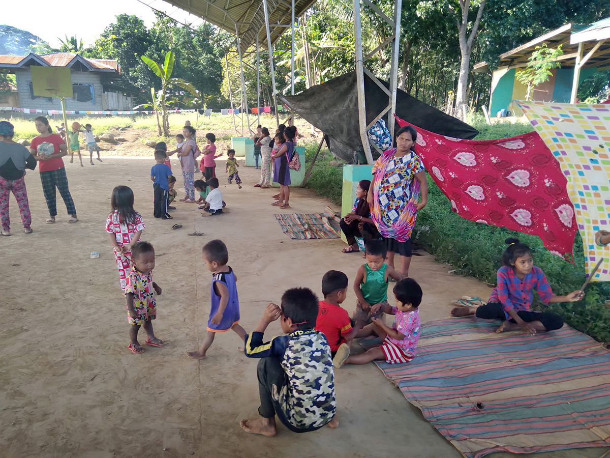 Women and children, many of them United Methodists, take shelter under the covered court of a local elementary school in the Arakan barangay of North Cotabato, Philippines. They fled their homes amid insecurity in the region. The families evacuated without clothes or other necessities, and The United Methodist Church in the Philippines is offering assistance. Photo courtesy of the Rev. Recto Baguio.